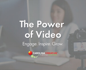 DSLR camera on a tripod recording a content creator at a desk in a modern workspace, representing Carolina Creative Group’s expertise in video marketing for businesses."